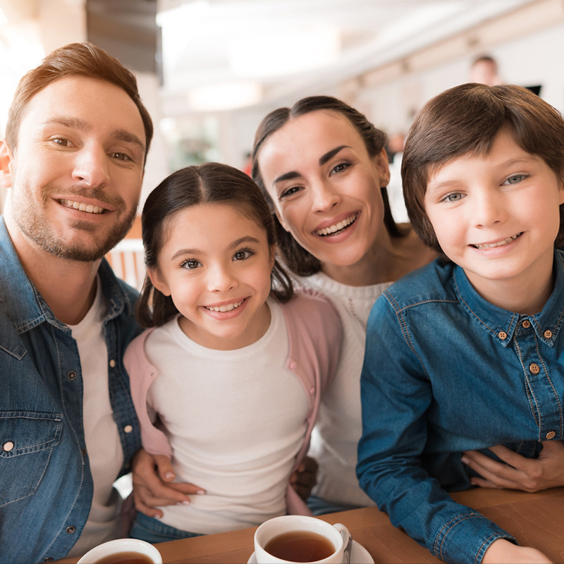 Family smiling, enjoying coffee